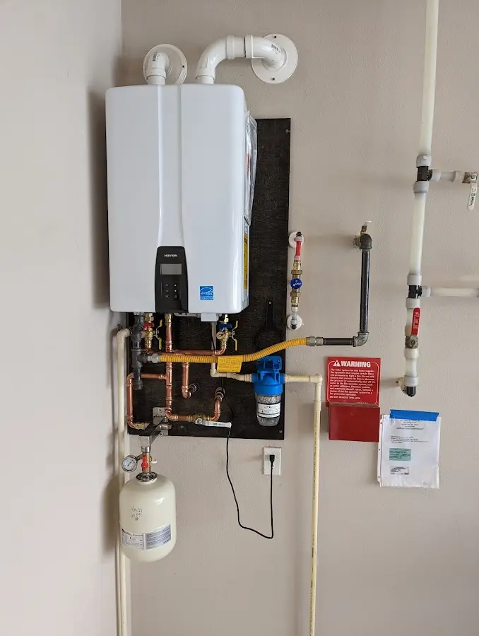 Professional plumber installing copper piping in a Lealman home